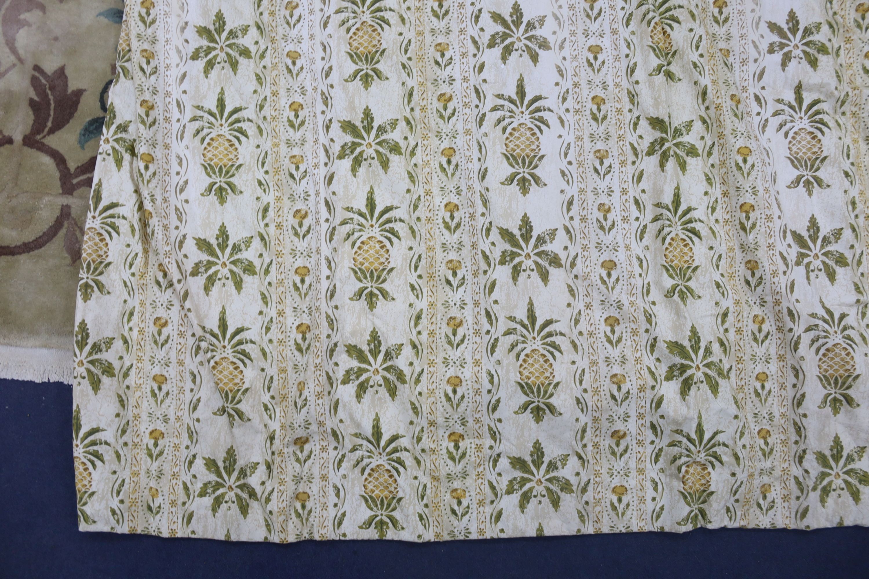 A pair of linen, 'Morris' style curtains and another pair of cotton curtains with a pineapple design